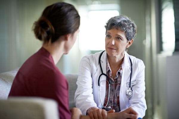 doctor discussing aggressive behavior after brain injury with survivor