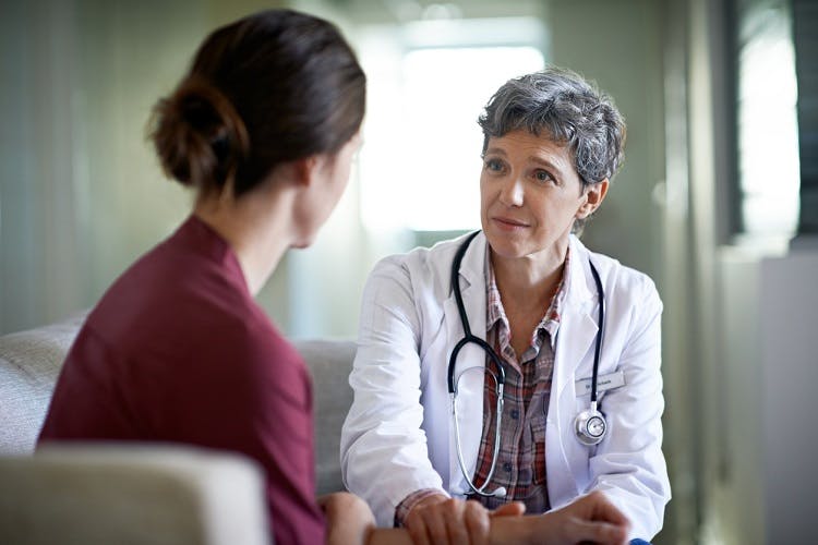 doctor discussing aggressive behavior after brain injury with survivor
