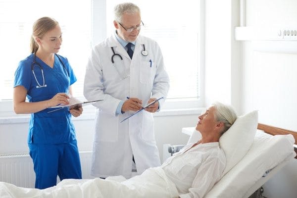 doctor and nurse explain diagnosis for aggressive behavior after stroke to hospital patient