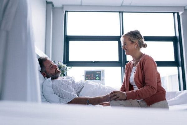 survivor in hospital bed waking up with post traumatic amnesia after brain injury