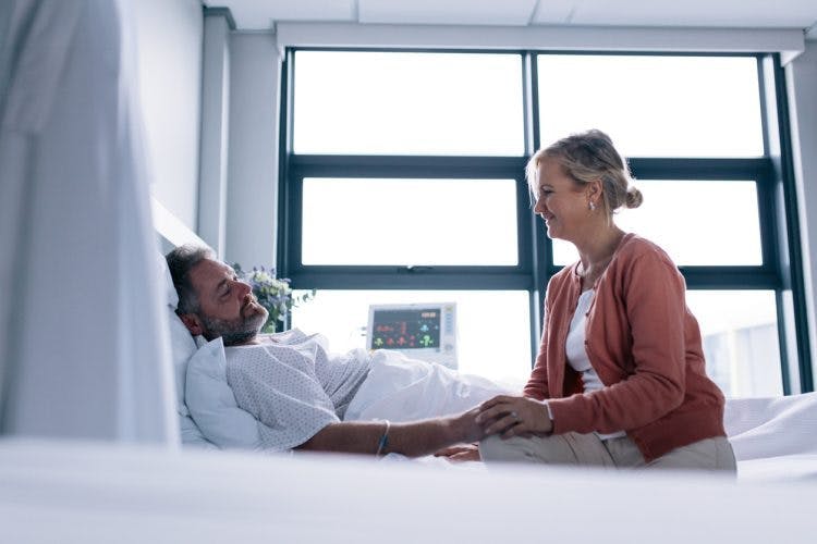 survivor in hospital bed waking up with post traumatic amnesia after brain injury