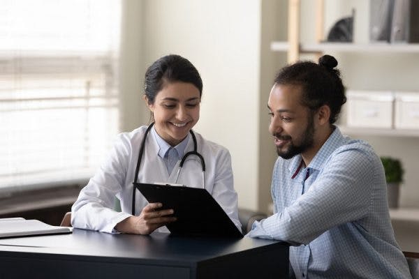therapist helping patient improve speech and language skills affected by apraxia after brain damage