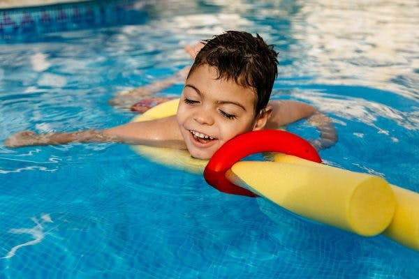 child with cerebral plasy participating in aquatic therapy to improve mobility