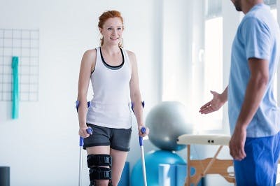 spinal cord injury patient participating in physical therapy to promote neuroplasticity
