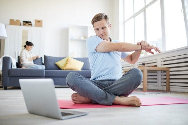 young adult with cerebral palsy stretching