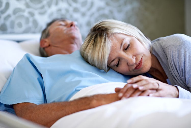 man in coma after brain injury with wife waiting next to him