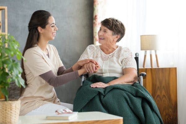 nurse helping woman with complete spinal cord injury