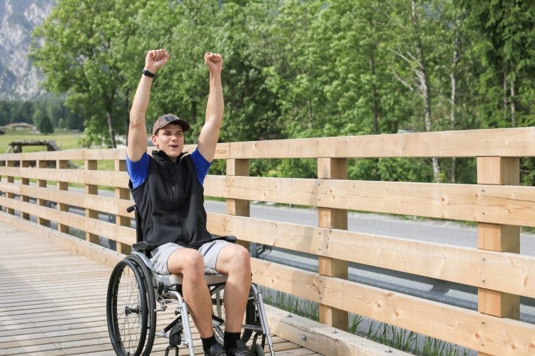 young man that is paralyzed from waist down using a wheelchair