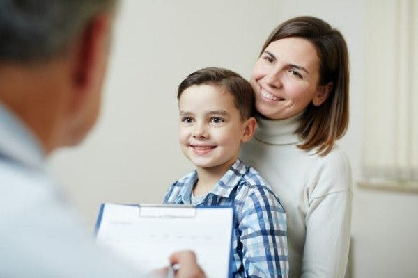 doctor explaining to patient's mother the various complications of cerebral palsy