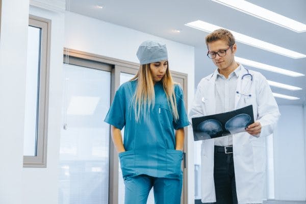 doctor and nurse analyzing scan of CTE after brain injury