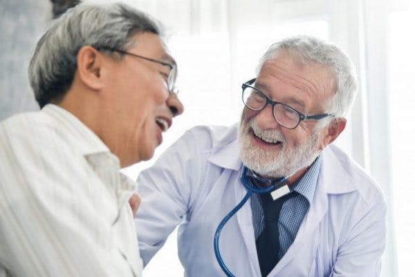 friendly speech language pathologist talking with stroke patient about recovery