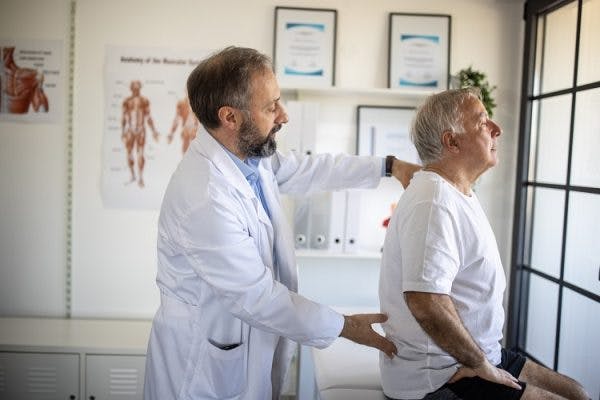 doctor checking survivor experiencing tingling and numbness after spinal cord injury