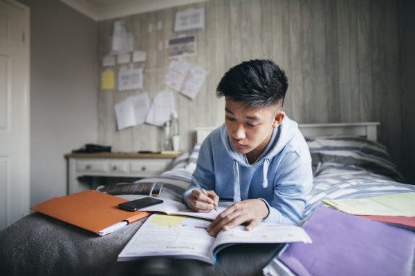 person studying from various books after brain injury