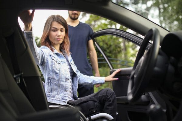 spinal cord injury survivor in wheelchair preparing to get in the car and drive again