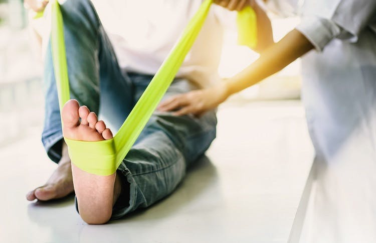 individual showing positive signs of healing foot drop while stretching