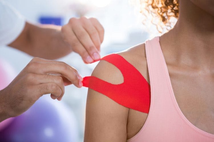 physical therapist taking stroke patient's shoulder