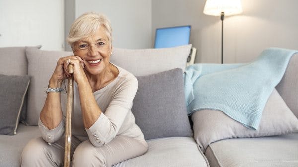 stroke patient holding cane before gait training exercises