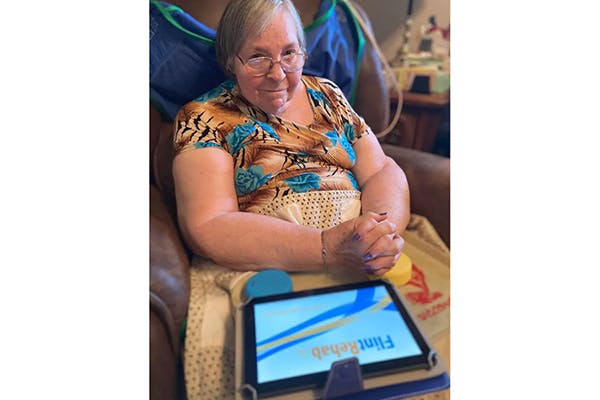 stroke survivor using the fitmi rehab device