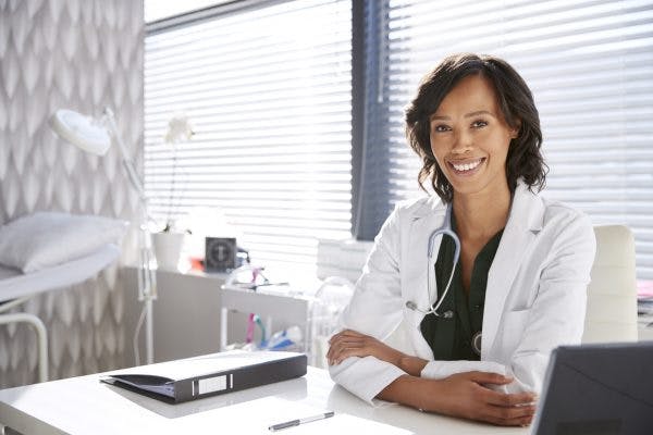 doctor sitting at desk reviewing signs of recovery from stroke
