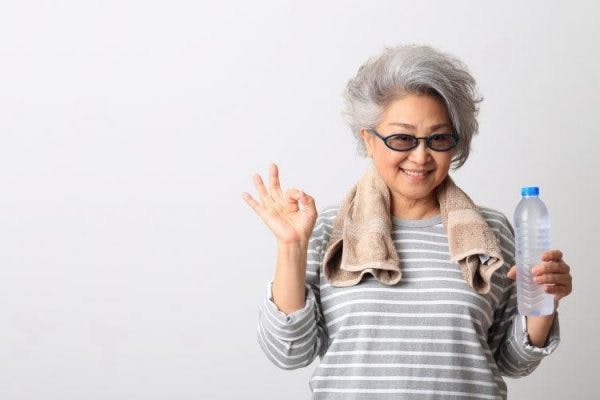 stroke patient touching thumb to index finger for hand exercise