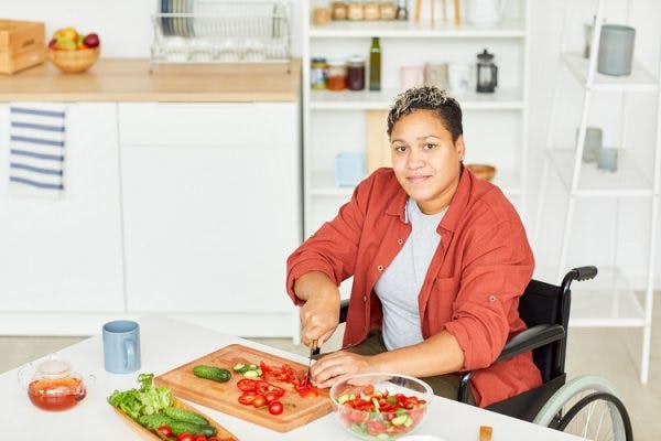 woman in wheelchair practicing skills learned at occupational therapy for spinal cord injury