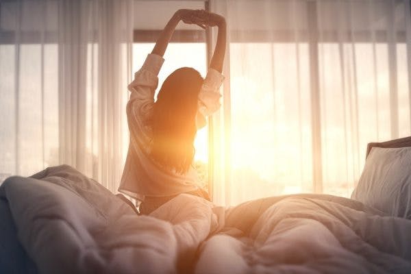 woman with post traumatic hypersomnia feeling well rested after engaging in excessive sleeping