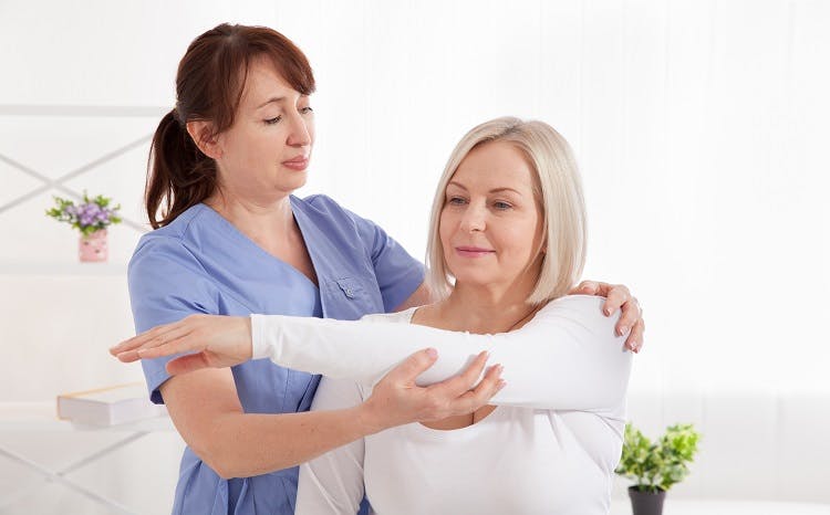 Doctor and patient in rehabilitation clinic after getting intrathecal baclofen pump to manage spasticity