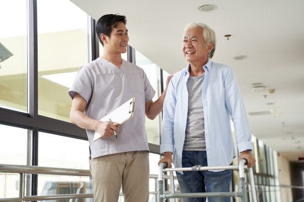 Young physical therapist talking to patient about long-term goals for brain injury patients