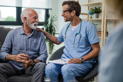 doctor and patient smiling and talking in office