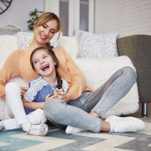 young girl with mild cerebral palsy playing with mother