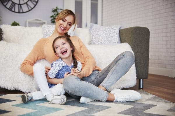 young girl with mild cerebral palsy playing with mother