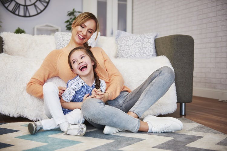 young girl with mild cerebral palsy playing with mother