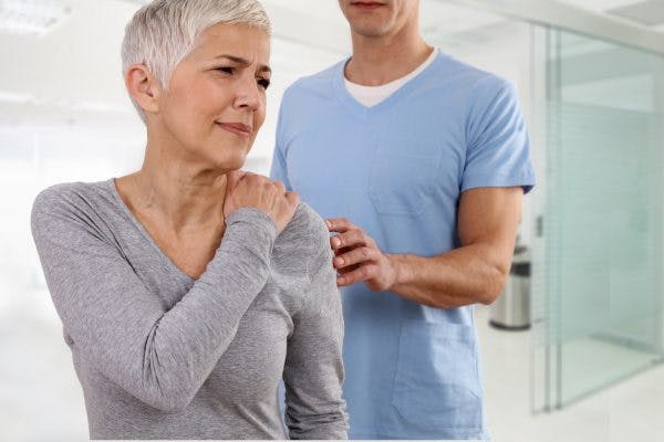 woman with muscle twitching after stroke working with physical therapist