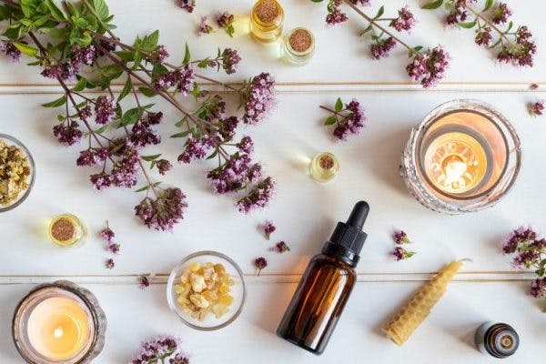 pieces of lavender arranged with natural remedies on white background