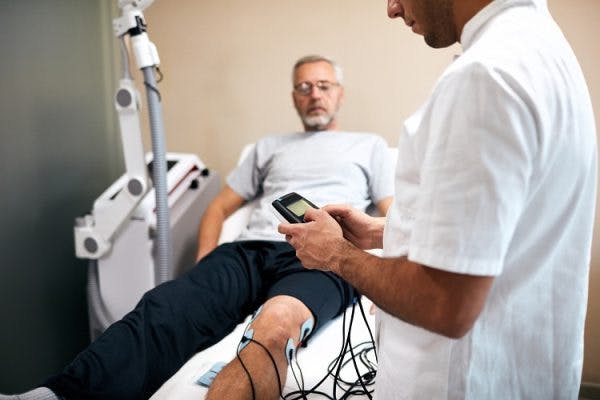 therapist discussing with patient why nerve stimulation is a good foot drop treatment