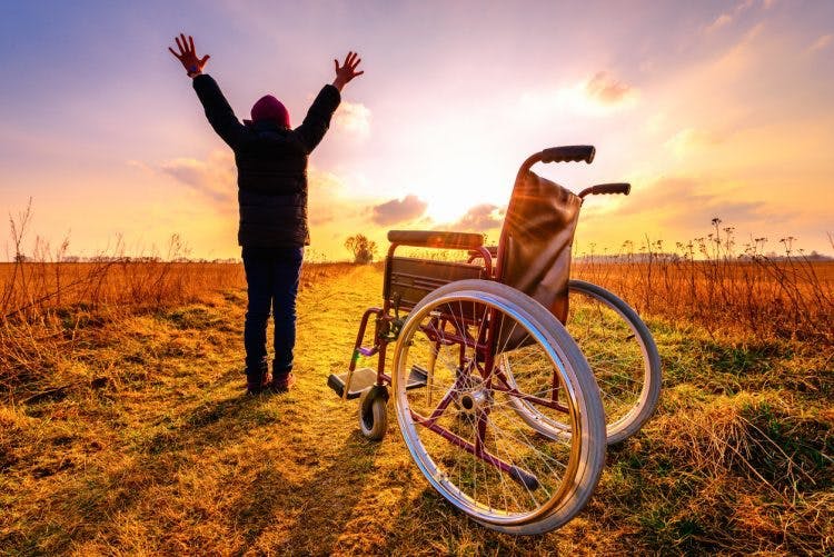 man celebrating spinal cord injury recovery through neuroplasticity