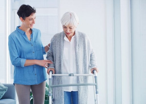 woman learning how to walk again with effective paralysis treatment exercises