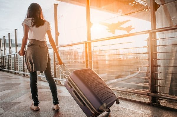 woman walking through airport ready for flying after brain injury
