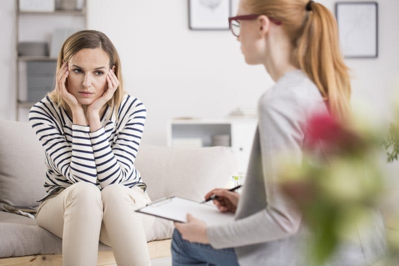 Woman getting help from psychologist for perseveration after brain injury