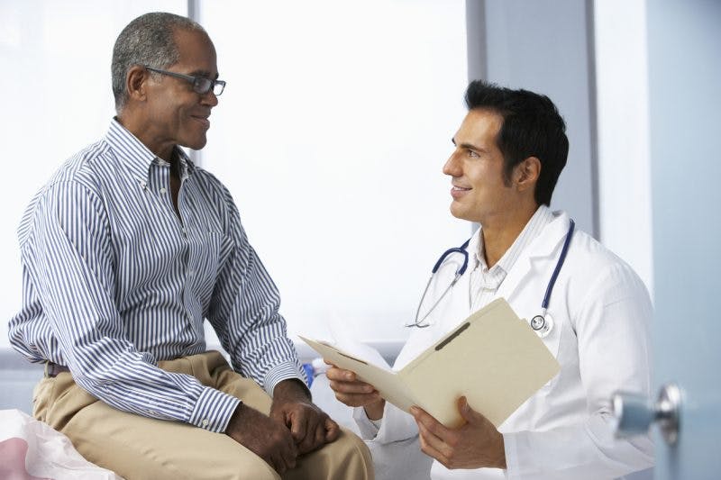 doctor explaining results of test to patient that shows he has pituitary dysfunction after brain injury
