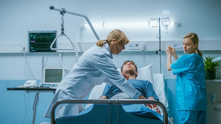 doctor assessing patient for abnormal posturing after severe brain injury