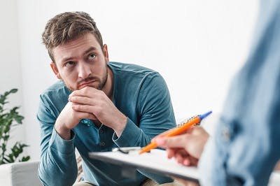 man with temporal lobe damage speaking to doctor about symptoms
