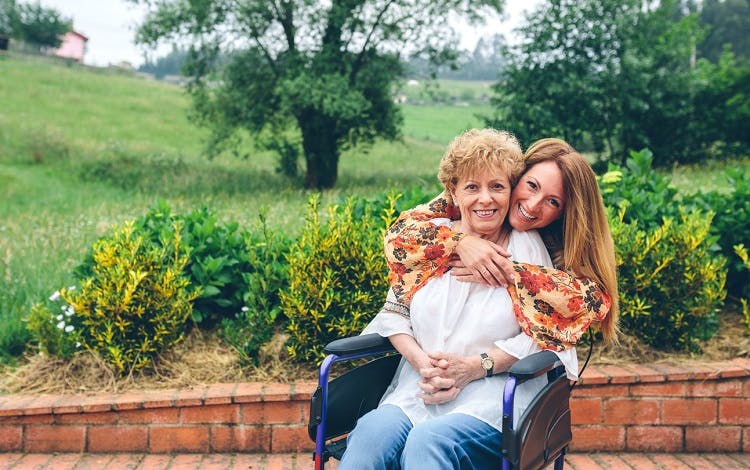 woman overcoming psychological effects of spinal cord injury with support of daughter