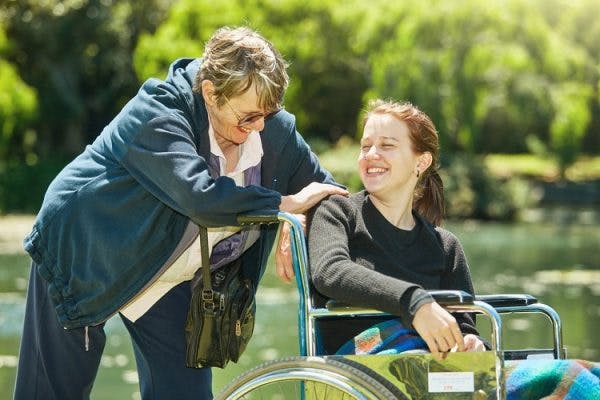 young woman in wheelchair living high quality of life after spinal cord injury