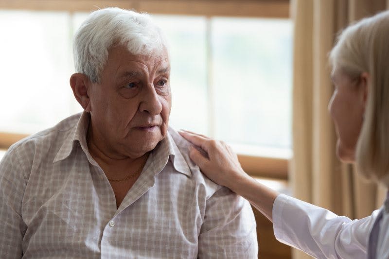 Doctor comforting stroke patient and telling him about second stroke survival