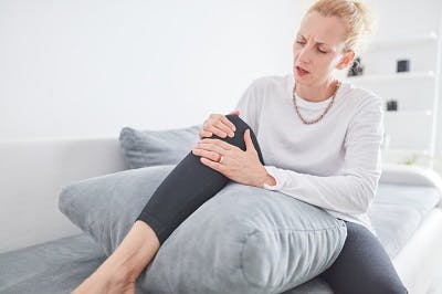woman experiencing discomfort from spasticity after spinal cord injury