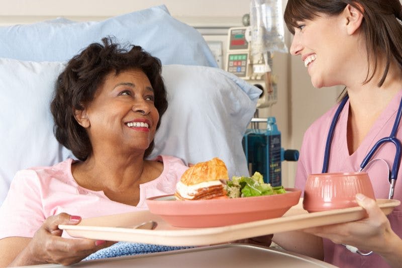 nurse helping a stroke patient that can't swallow after stroke