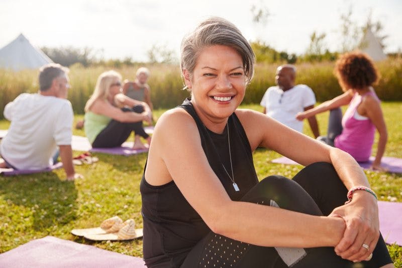 stroke patient sitting outside on yoga mat 5 years after stroke