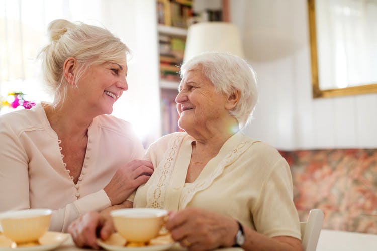 caregiver comforting a stroke survivor at home after a dizzy spell
