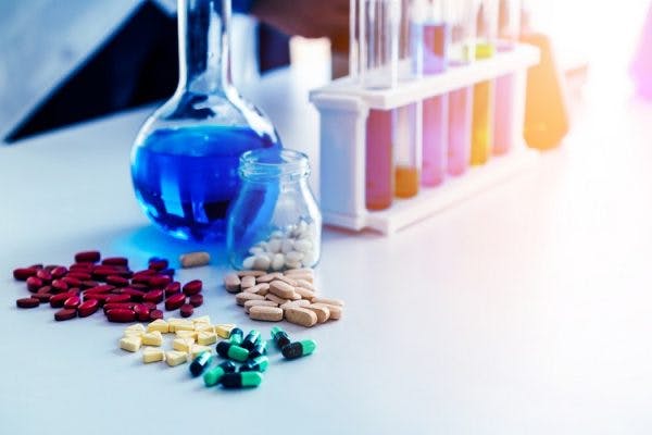 various vitamins for cerebral palsy arranged on a lab table with test tubes in the background